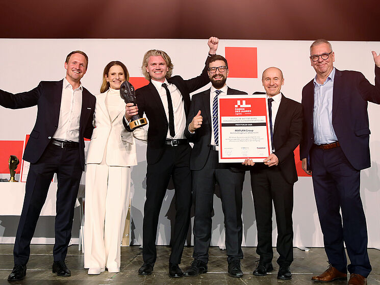 FACTORY OF THE YEAR CATEGORY WINNER MAPLAN on the stage getting their award